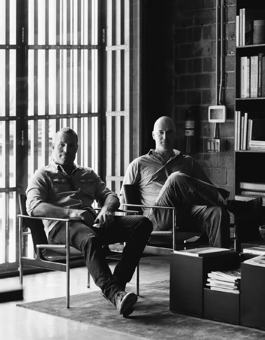 WF-Vision-Photo Two men sitting in chairs in front of a bookcase.
